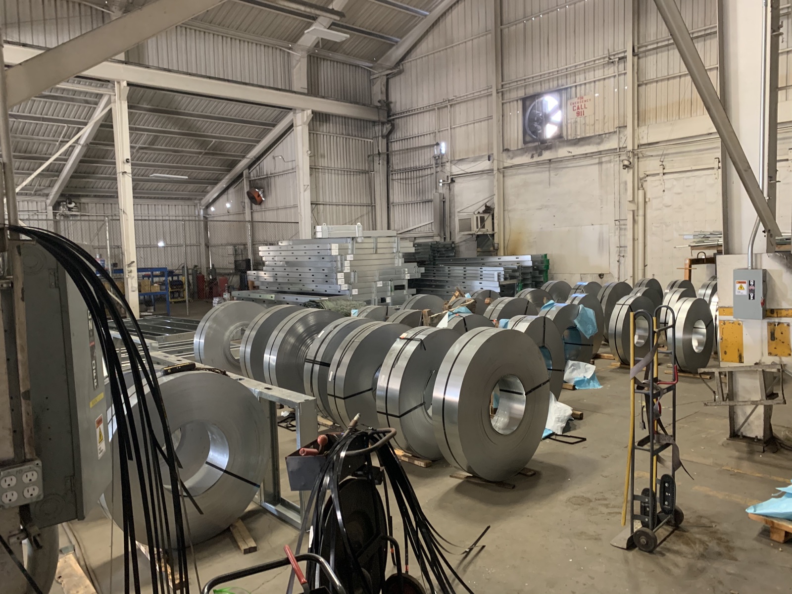 Master steel coils and the slitting line on the Cal Steel production floor.