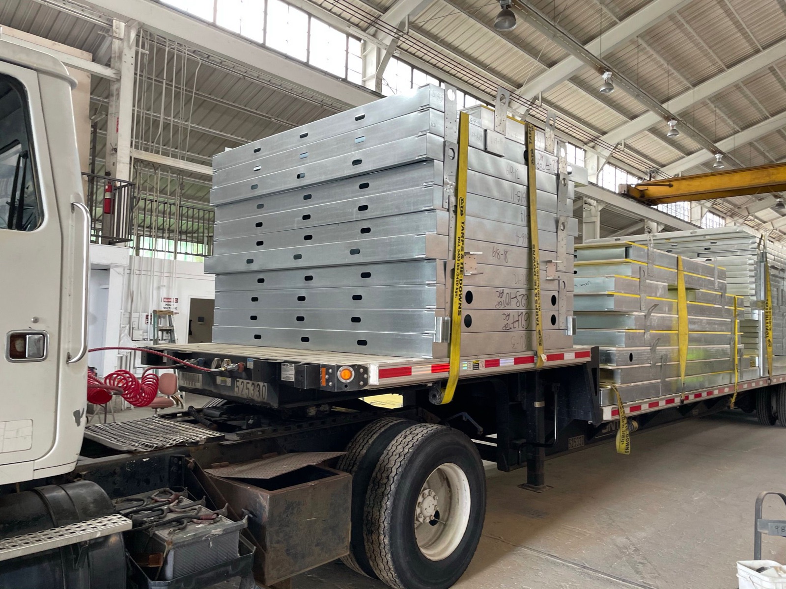 Panelized light gauge steel assemblies loaded on a flatbed.