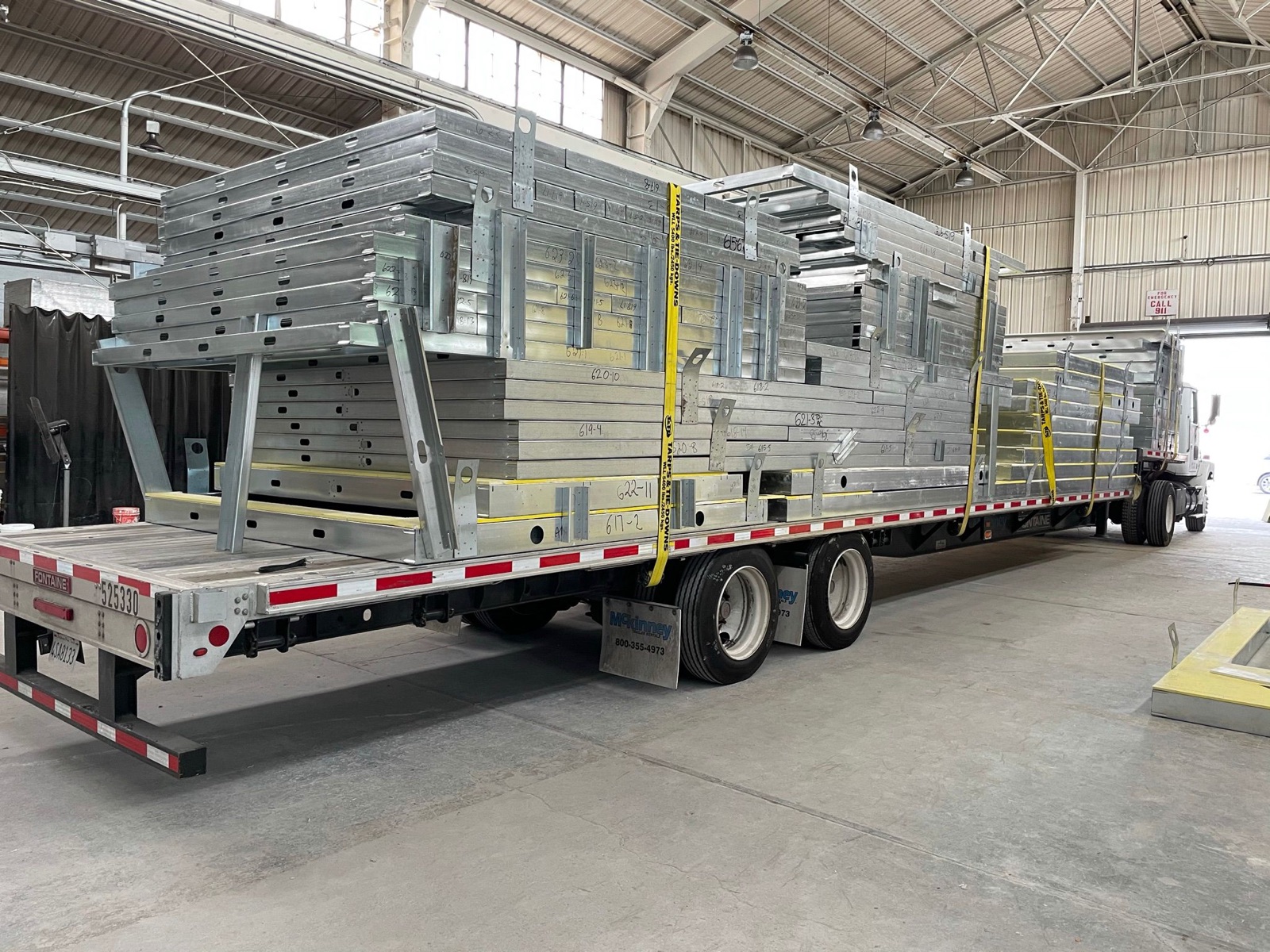 A flatbed loaded with panelized light gauge steel framing, ready to ship.