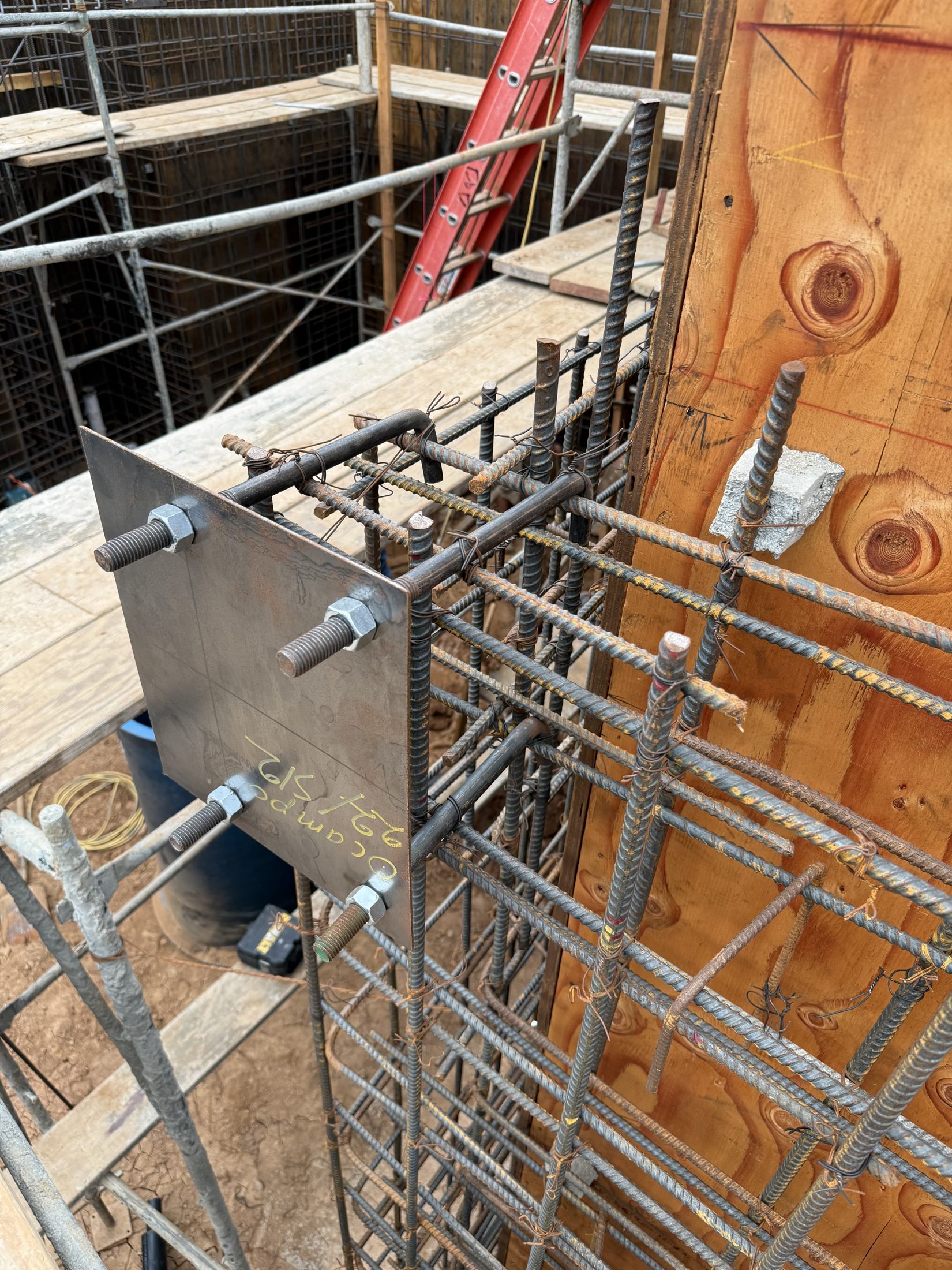 A cast-in structural steel embed plate set in the foundation rebar at 777 Ocampo
