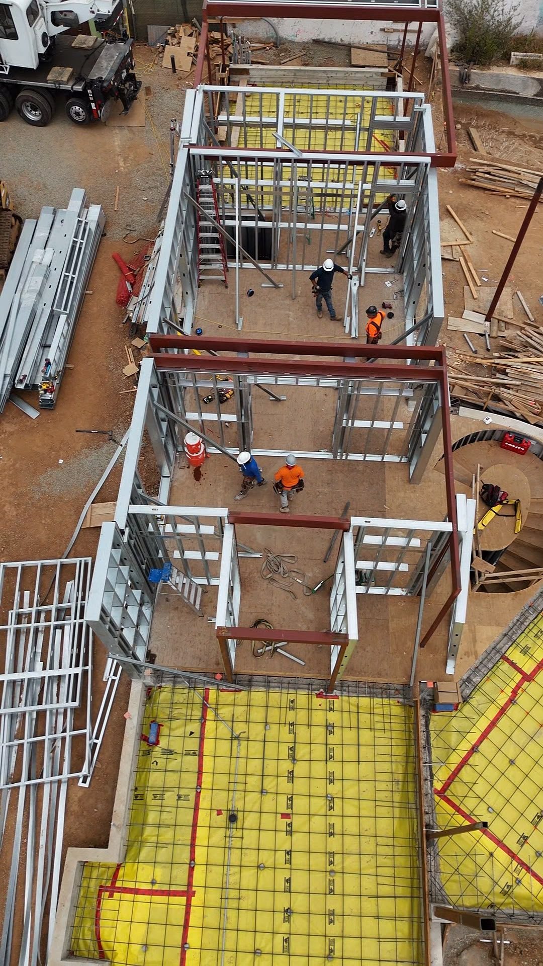 Drone view of the structural steel column grid spanning the ground-floor slab at 777 Ocampo