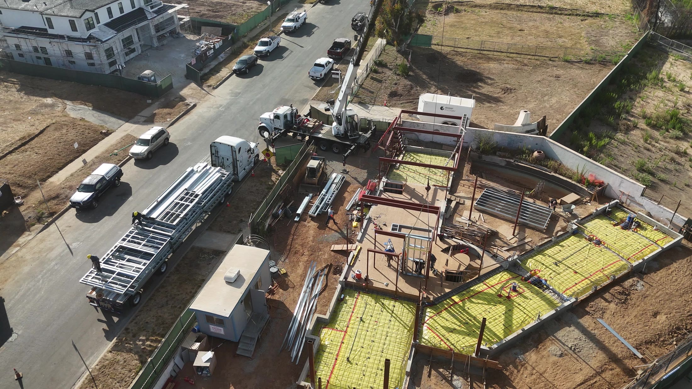 Aerial flyover of the ground-floor structural steel frame taking shape at 777 Ocampo, Pacific Palisades